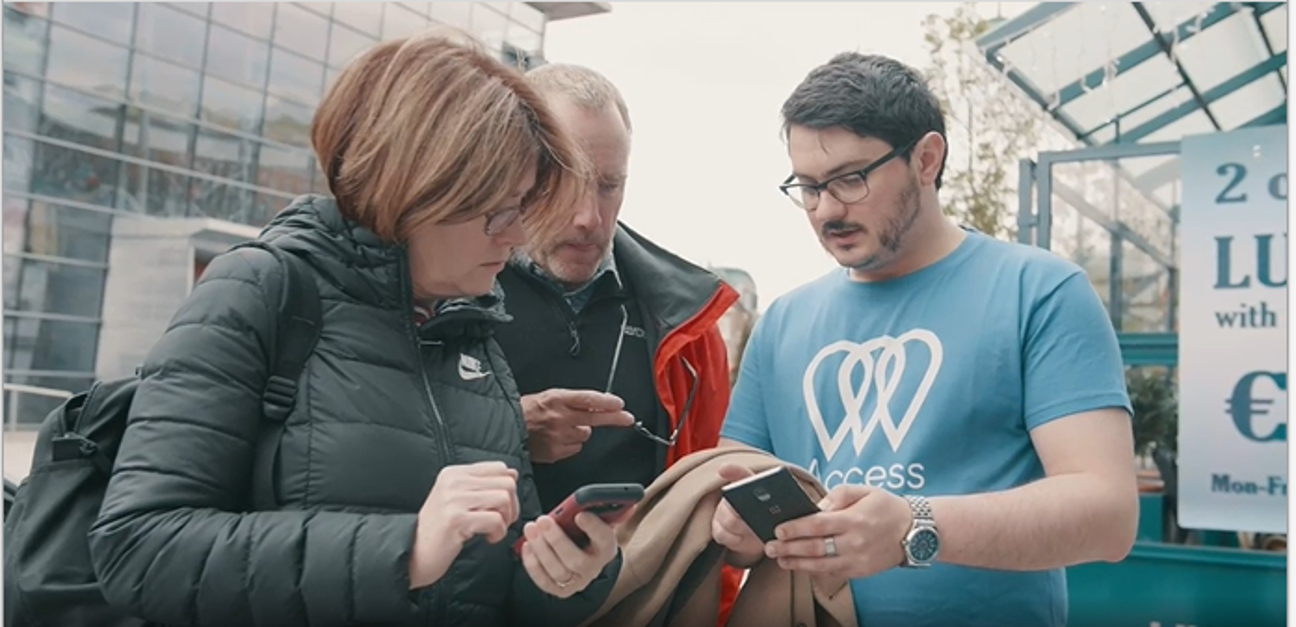 WP61 Access Earth team member with mapping event participants using the Access Earth app on their mobile phones