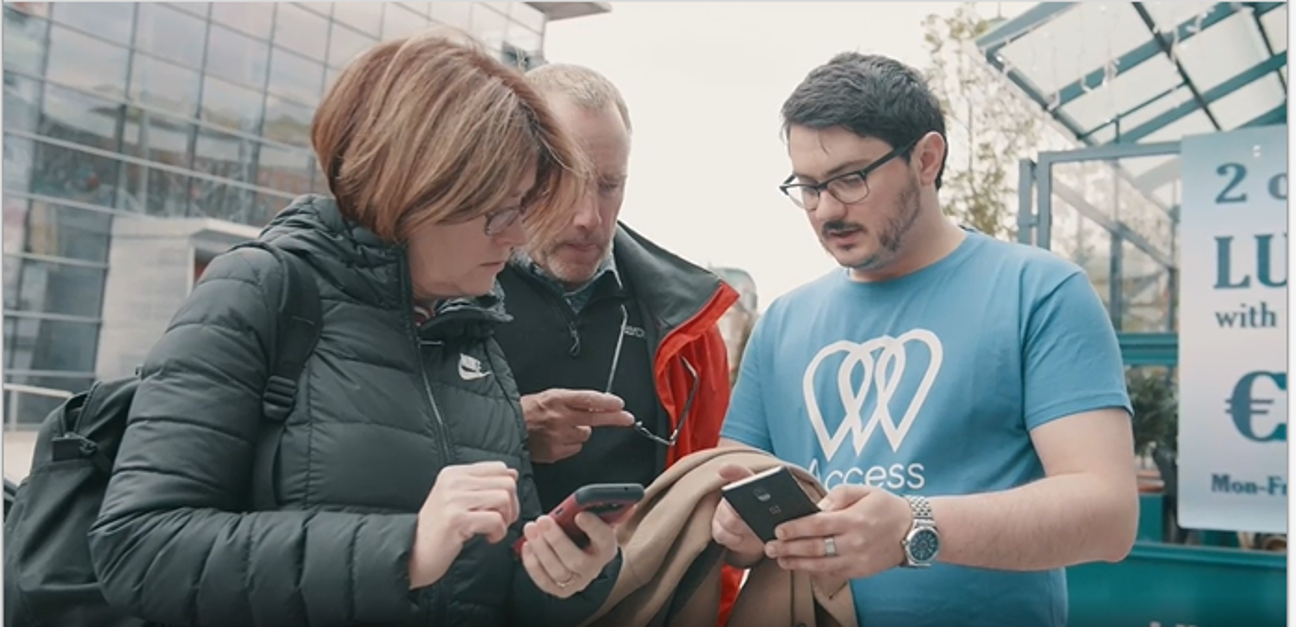 Access Earth team member with mapping event participants using the Access Earth app on their mobile phones