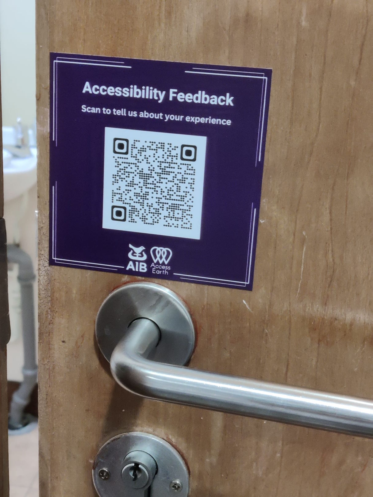 A QR Code for the Accessibility Feedback System on the front of a door